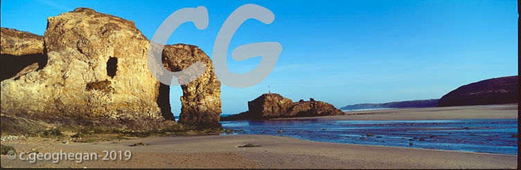 Early Morning on the Beach, A Rock Arch on the Empty Beach.